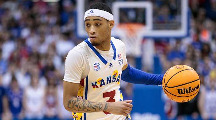 Kansas’s Dajuan Harris brings up the ball.